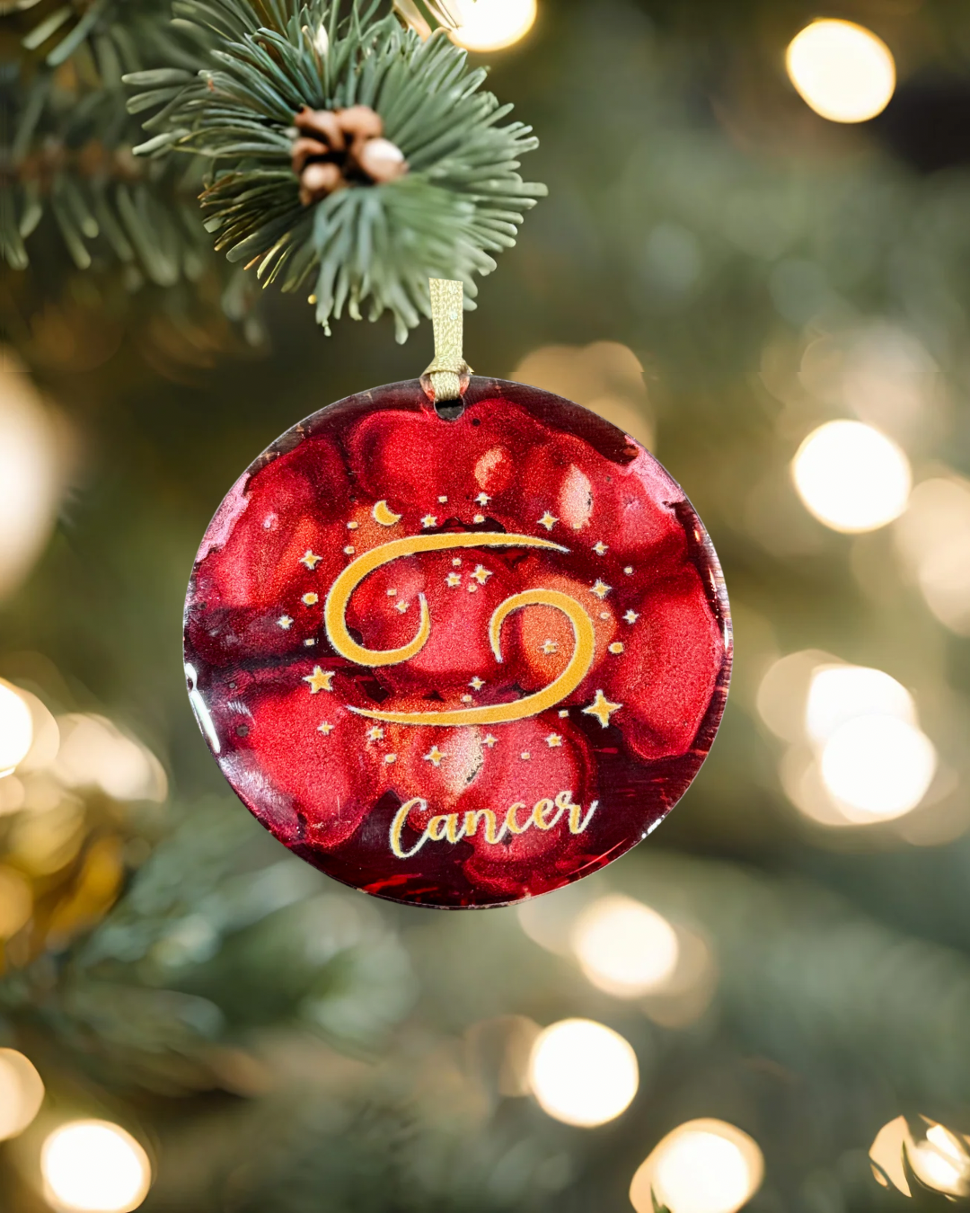 Decorative Christmas ornament with 'Cancer' zodiac sign on a tree