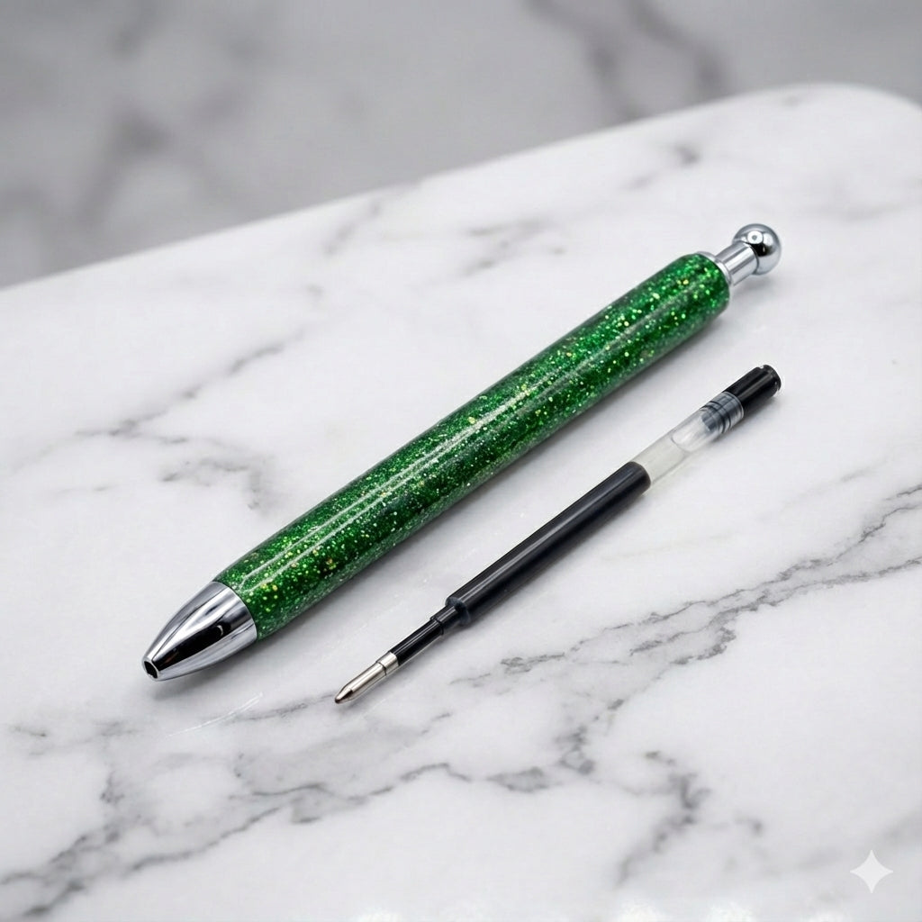 Green glitter pen with silver accents on a marble surface