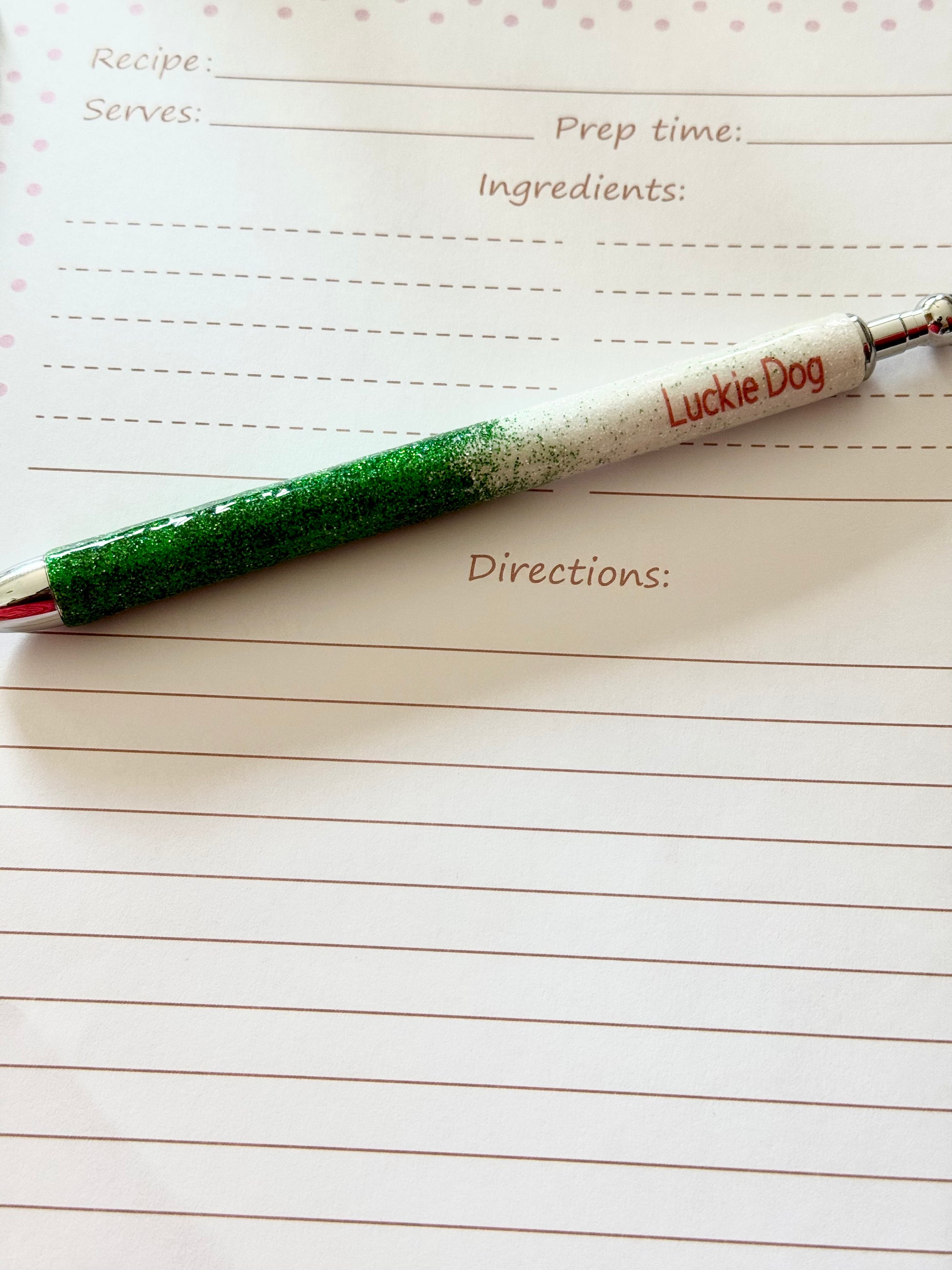 Green and white pen labeled 'Lucky Dog' on a lined paper sheet.