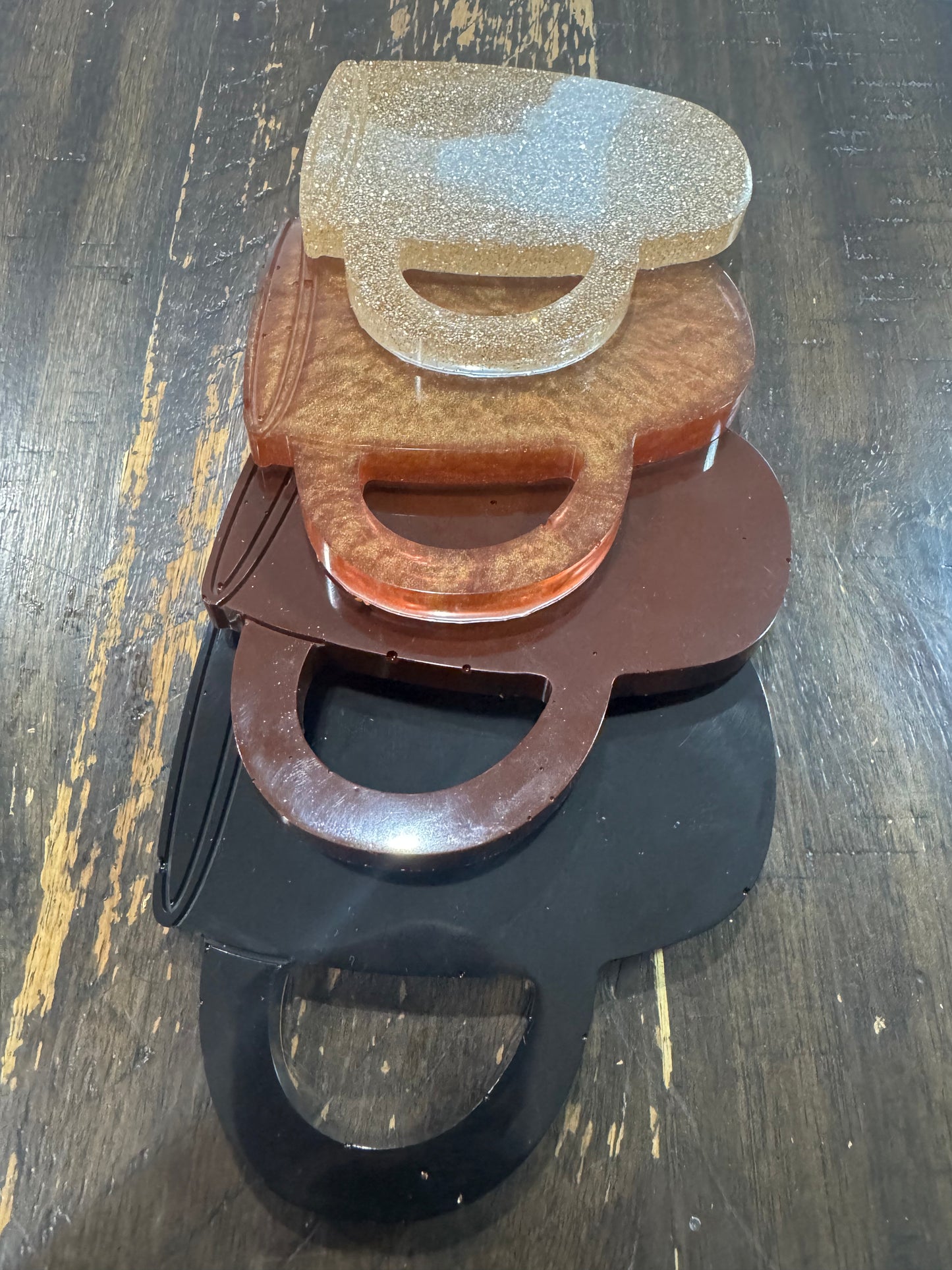 Set of four varying brown color cup shaped coasters