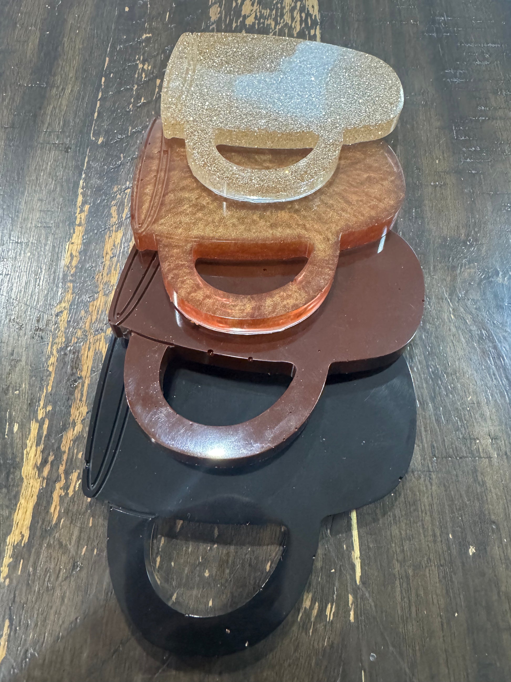 Set of four varying brown color cup shaped coasters