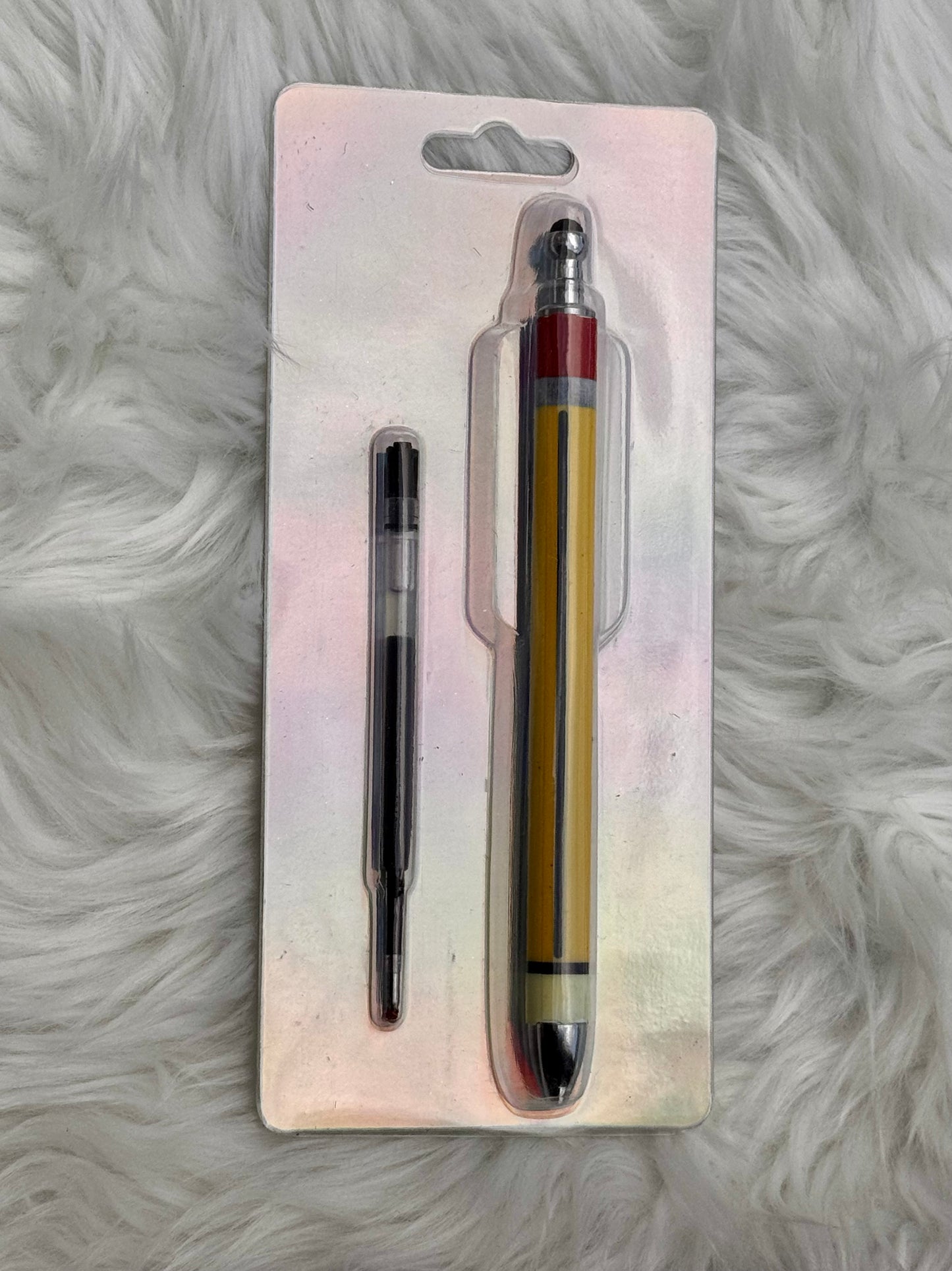 A stylus pen and its replacement ink cartridge, both in their original blister card packaging, displayed on a white faux fur surface.
