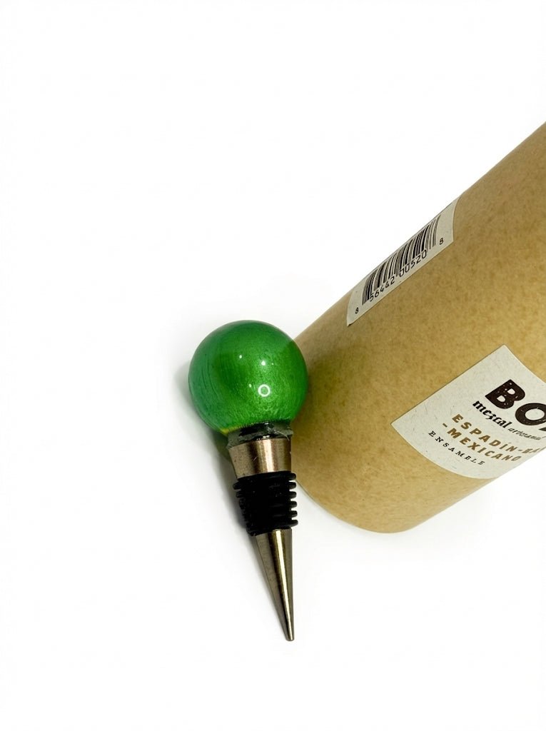 Green bottle stopper with metallic tip on a white background
