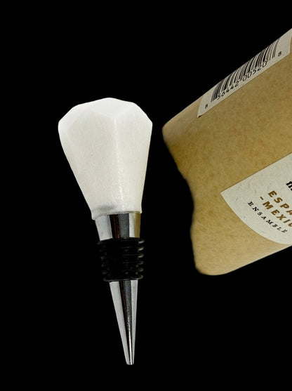 White bottle stopper with metallic base on a white background